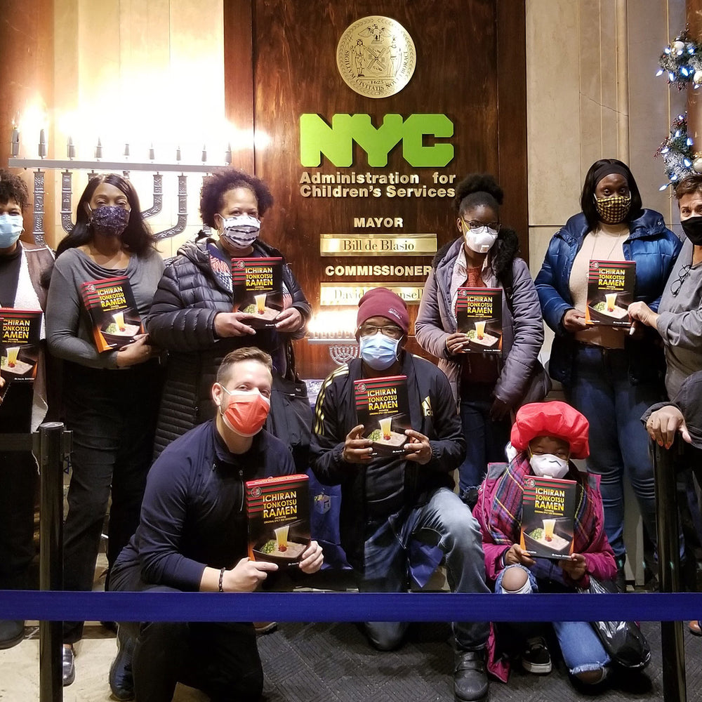 Staff, volunteers, and members of New Yorkers for Children holding ICHIRAN ramen kits